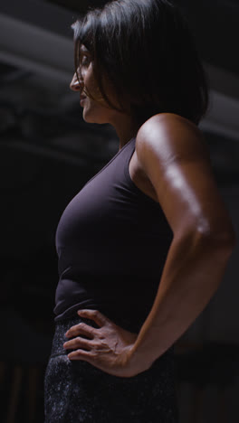 Vertical-Video-Portrait-Of-Mature-Woman-Wearing-Fitness-Clothing-Standing-In-Gym-Ready-To-Exercise